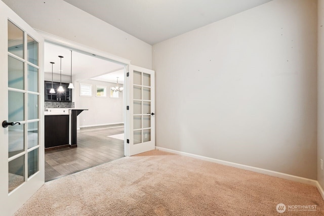 4335 Dudley Dr NE, Lacey, WA 98516 - empty room featuring french doors, carpet flooring, baseboards, and a notable chandelier