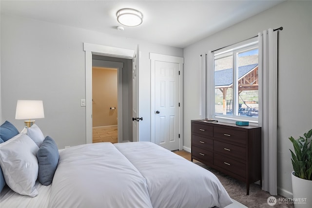 bedroom with a closet and baseboards