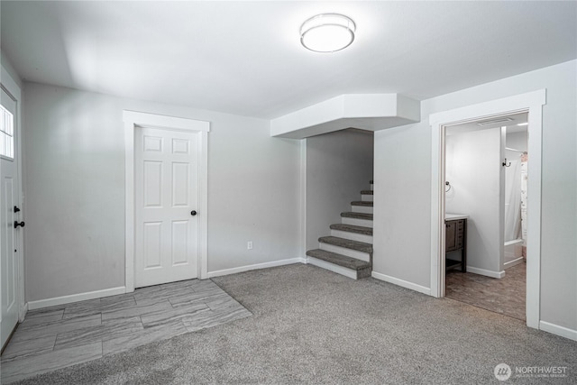 interior space with baseboards, carpet floors, and stairs
