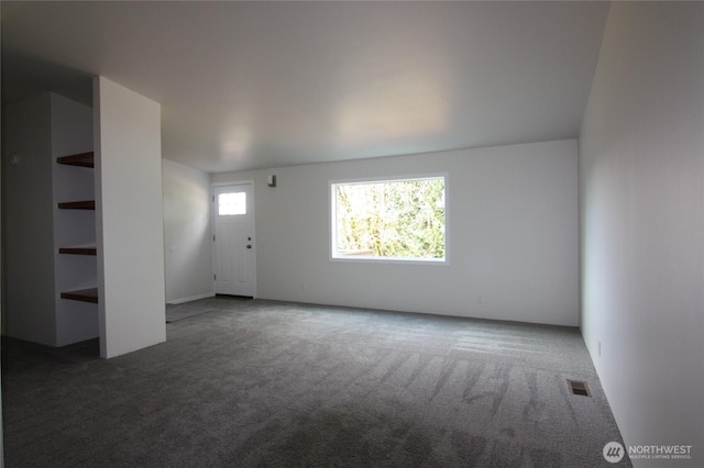 unfurnished living room with carpet flooring and visible vents