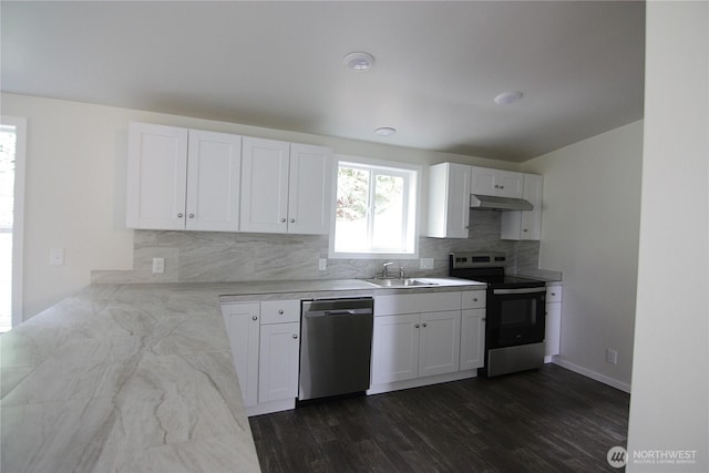 kitchen with a sink, appliances with stainless steel finishes, under cabinet range hood, white cabinets, and decorative backsplash