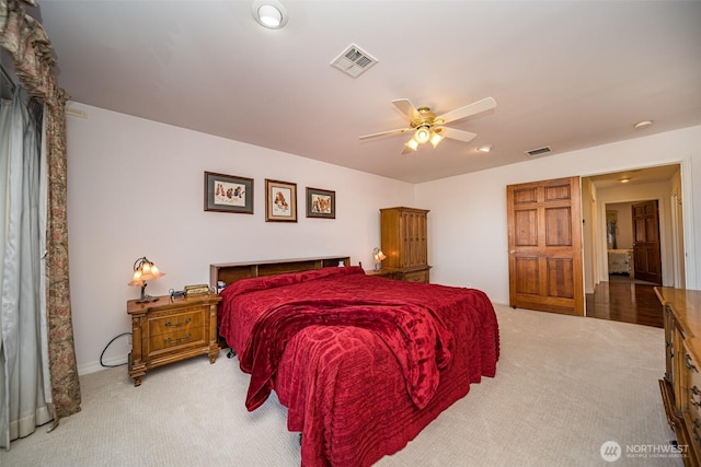 carpeted bedroom with visible vents and a ceiling fan