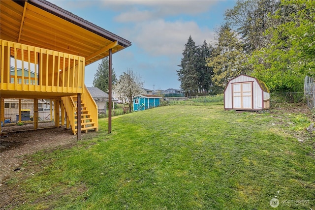 1023 S 88th St, Tacoma, WA 98444 - view of yard featuring an outdoor structure, a fenced backyard, stairway, and a shed