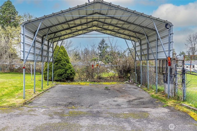 1023 S 88th St, Tacoma, WA 98444 - view of vehicle parking featuring driveway, a detached carport, and fence