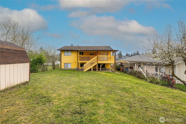 1023 S 88th St, Tacoma, WA 98444 - back of property with a deck, a lawn, fence, stairs, and an outbuilding