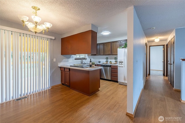 1023 S 88th St, Tacoma, WA 98444 - kitchen featuring stainless steel dishwasher, white fridge with ice dispenser, a peninsula, visible vents, and a chandelier
