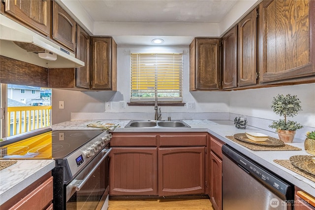 1023 S 88th St, Tacoma, WA 98444 - kitchen featuring under cabinet range hood, light countertops, a sink, and appliances with stainless steel finishes