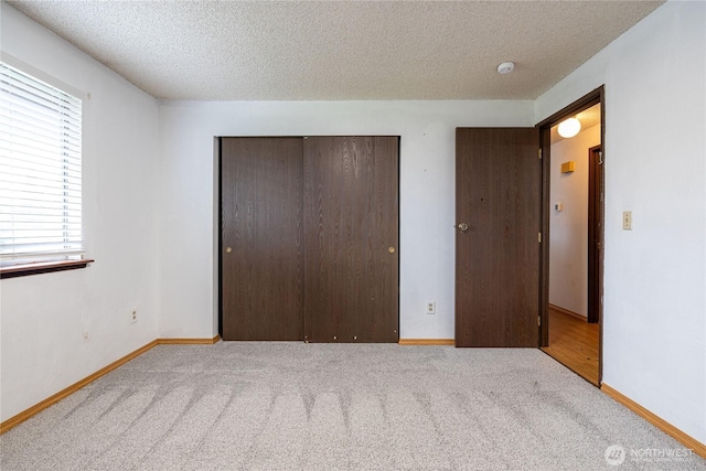 1023 S 88th St, Tacoma, WA 98444 - unfurnished bedroom with a textured ceiling, a closet, baseboards, and carpet