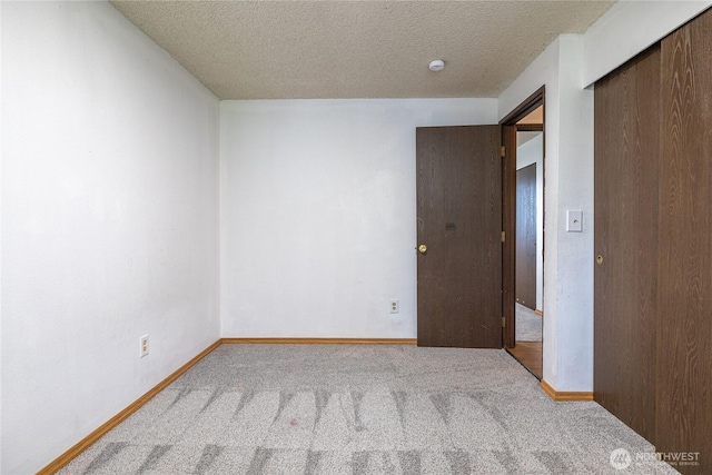 1023 S 88th St, Tacoma, WA 98444 - unfurnished bedroom with a closet, baseboards, carpet, and a textured ceiling