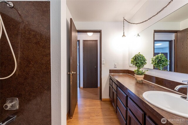 1023 S 88th St, Tacoma, WA 98444 - full bathroom with vanity, baseboards, and wood finished floors