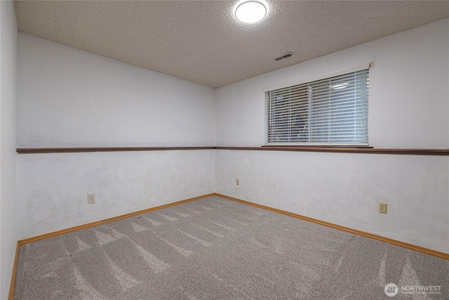 1023 S 88th St, Tacoma, WA 98444 - empty room with carpet, visible vents, a textured ceiling, and baseboards