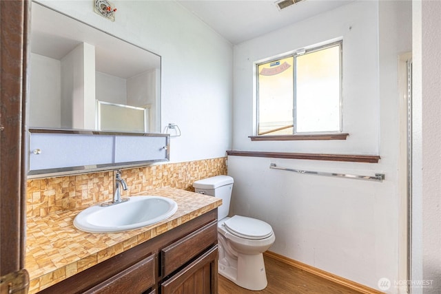 1023 S 88th St, Tacoma, WA 98444 - bathroom featuring tasteful backsplash, vanity, toilet, wood finished floors, and walk in shower