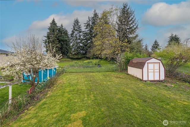 1023 S 88th St, Tacoma, WA 98444 - view of yard featuring a storage shed, a fenced backyard, and an outbuilding