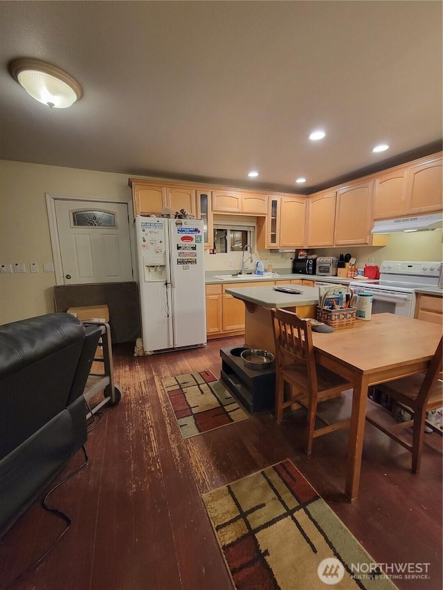 kitchen featuring wood-type flooring, light countertops, white appliances, and under cabinet range hood
