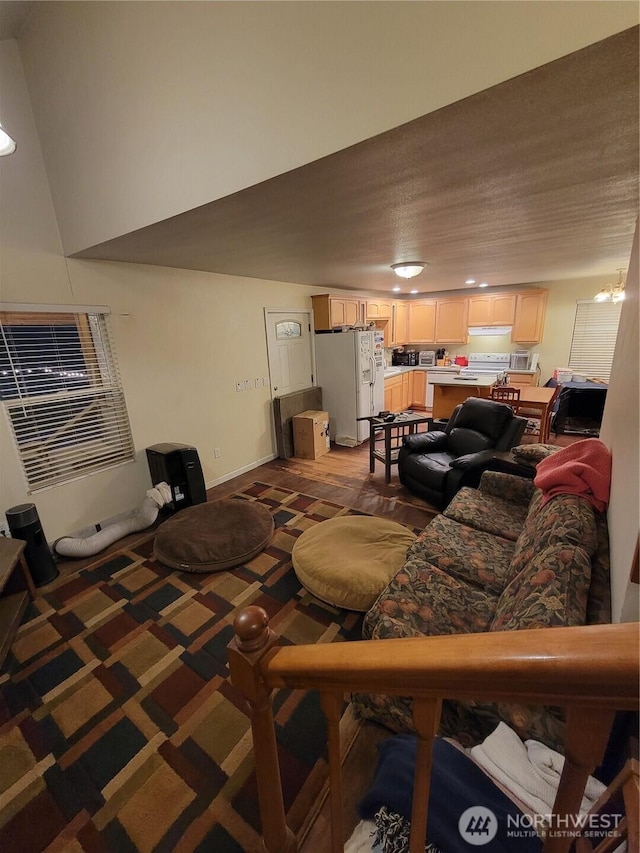 living area with baseboards and carpet floors