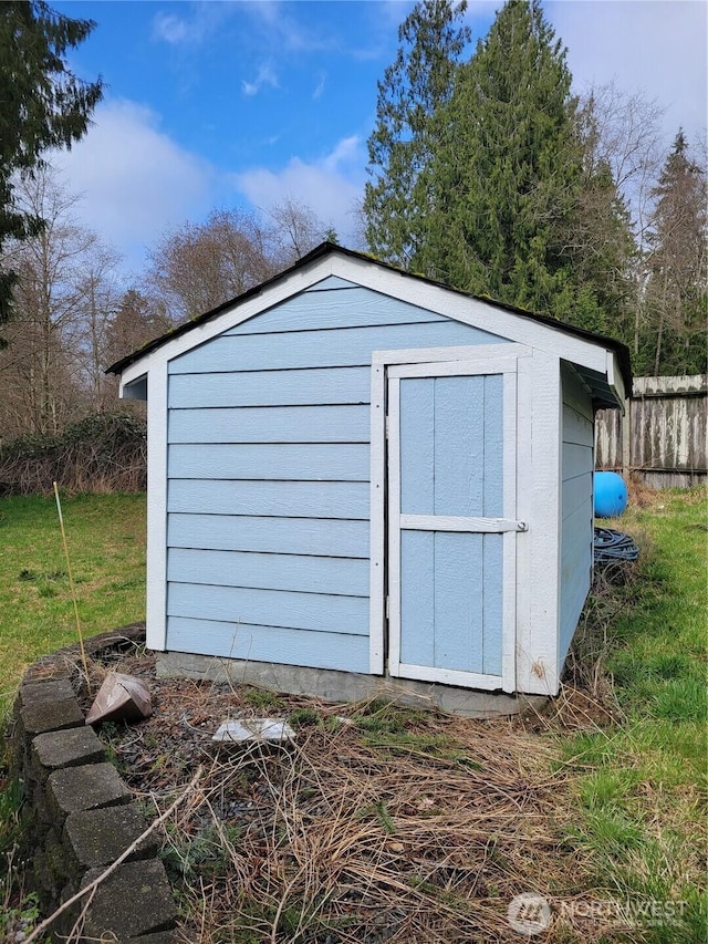 view of shed featuring fence