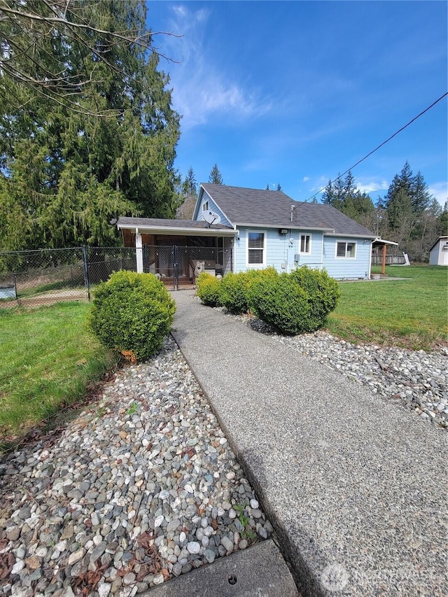 ranch-style home with a carport, concrete driveway, fence, and a front lawn