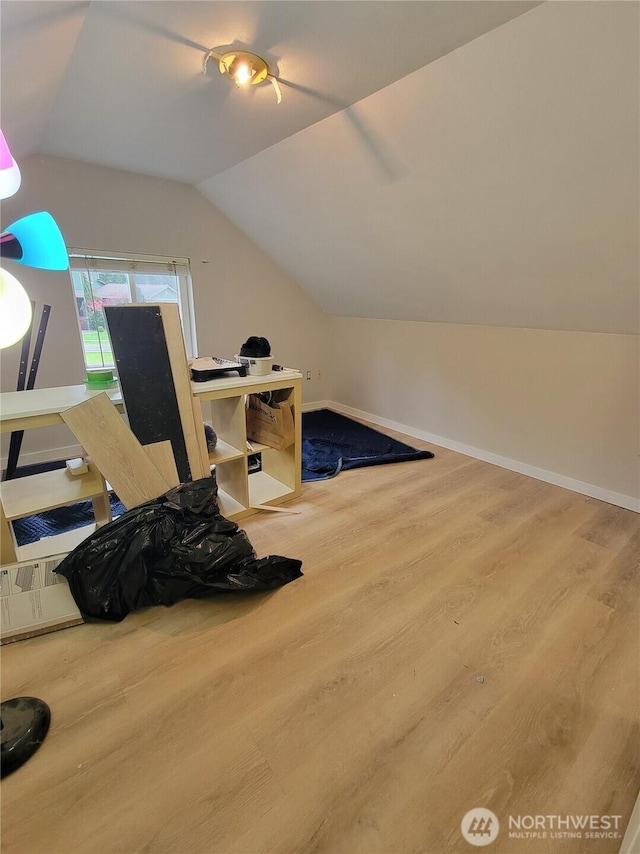 bonus room with baseboards, wood finished floors, and lofted ceiling