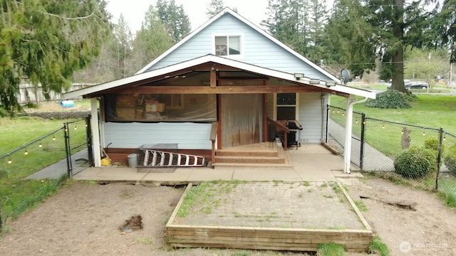 back of property featuring fence and a lawn