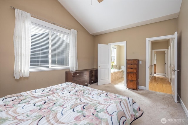 660 Parkside Pl, Blaine, WA 98230 - bedroom with light colored carpet, baseboards, vaulted ceiling, and connected bathroom