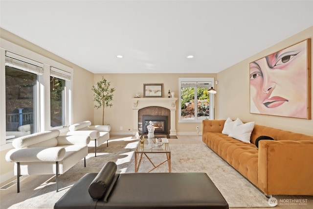 living room with baseboards, recessed lighting, carpet flooring, and a fireplace with flush hearth