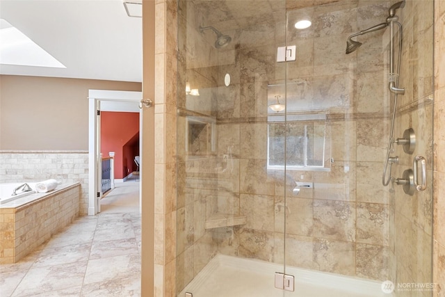 bathroom with a shower stall and a bath