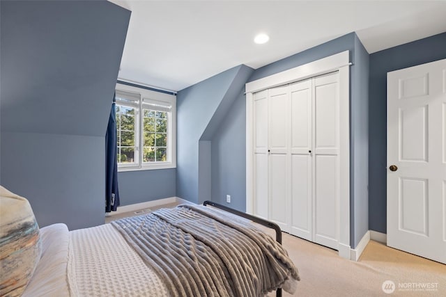 bedroom with light carpet, recessed lighting, baseboards, and a closet