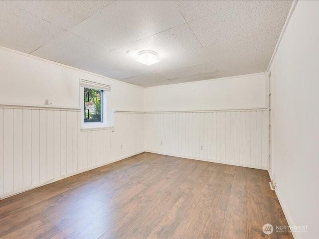 8434 34th Ave S, Seattle, WA 98118 - spare room featuring wood finished floors and wainscoting