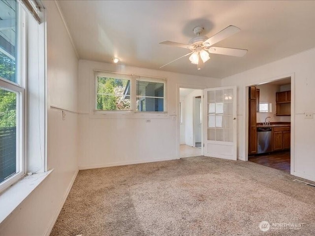 8434 34th Ave S, Seattle, WA 98118 - carpeted spare room featuring a ceiling fan, baseboards, and a sink