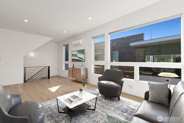 3929 2nd Ave NE, Seattle, WA 98105 - living area featuring a wall unit AC, wood finished floors, and recessed lighting