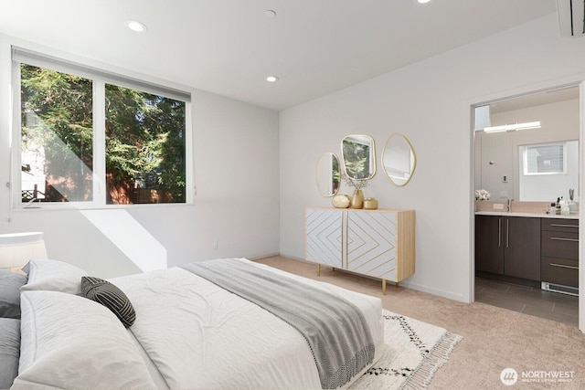 3929 2nd Ave NE, Seattle, WA 98105 - bedroom with light colored carpet, ensuite bath, and recessed lighting