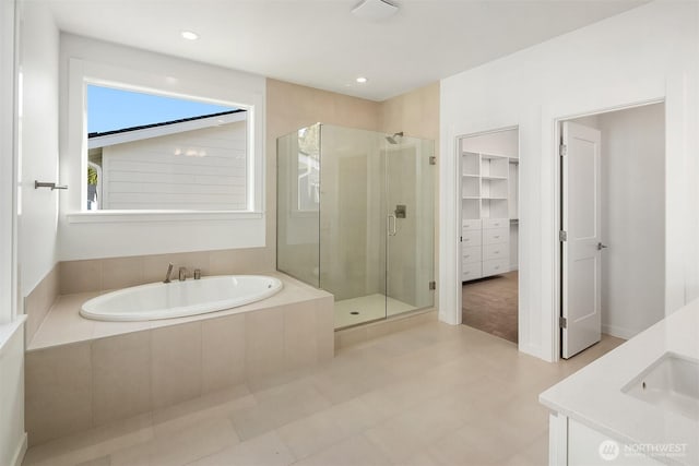 25520LOT22 204th Pl SE, Covington, WA 98042 - bathroom with a stall shower, a sink, a walk in closet, a bath, and recessed lighting