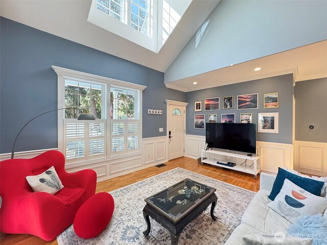 861 Kirner Rd, Sequim, WA 98382 - living area featuring wainscoting, a high ceiling, a decorative wall, crown molding, and wood finished floors