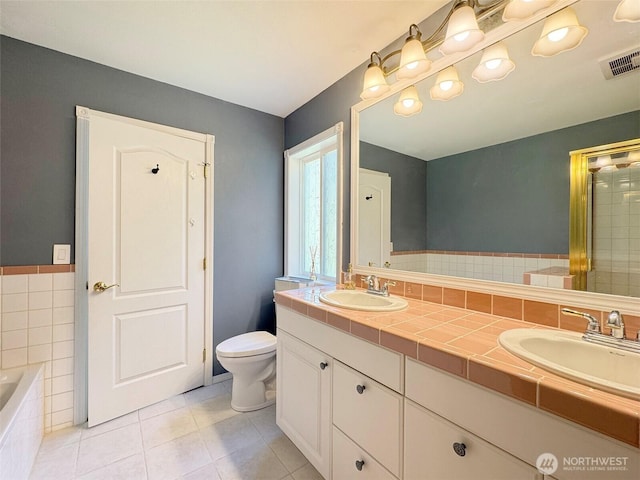 861 Kirner Rd, Sequim, WA 98382 - full bath with double vanity, tile patterned floors, tiled tub, and toilet