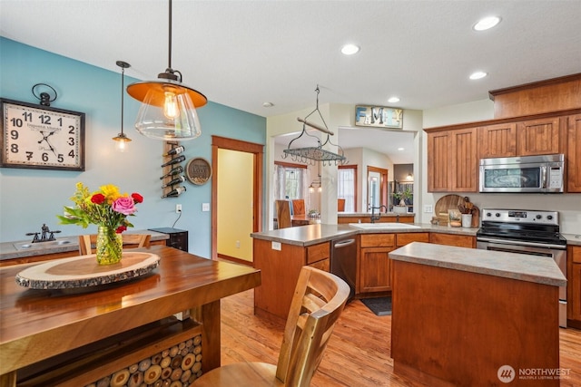 14900 NE Critter Hill Dr, Amboy, WA 98601 - kitchen with appliances with stainless steel finishes, a peninsula, a sink, light wood-style flooring, and recessed lighting