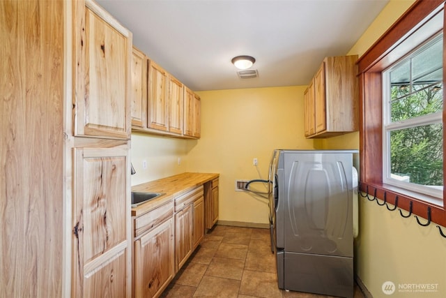 14900 NE Critter Hill Dr, Amboy, WA 98601 - laundry area with cabinet space, washer / dryer, baseboards, and light tile patterned flooring