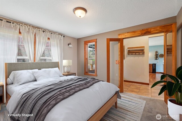 14900 NE Critter Hill Dr, Amboy, WA 98601 - tiled bedroom featuring baseboards and a textured ceiling