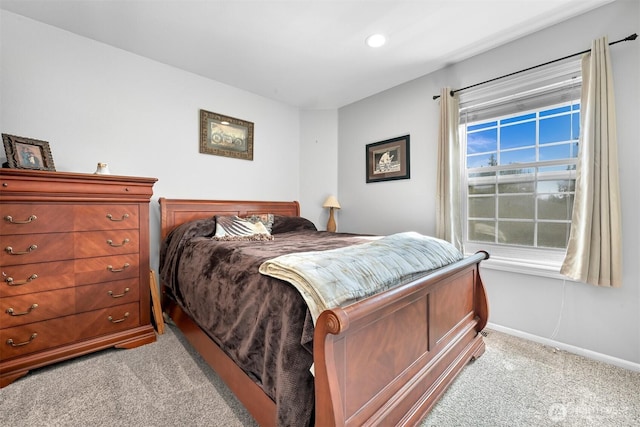 bedroom with light carpet, recessed lighting, and baseboards