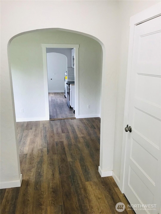 201 S 60th St, Tacoma, WA 98408 - hall with arched walkways, dark wood-style flooring, and baseboards