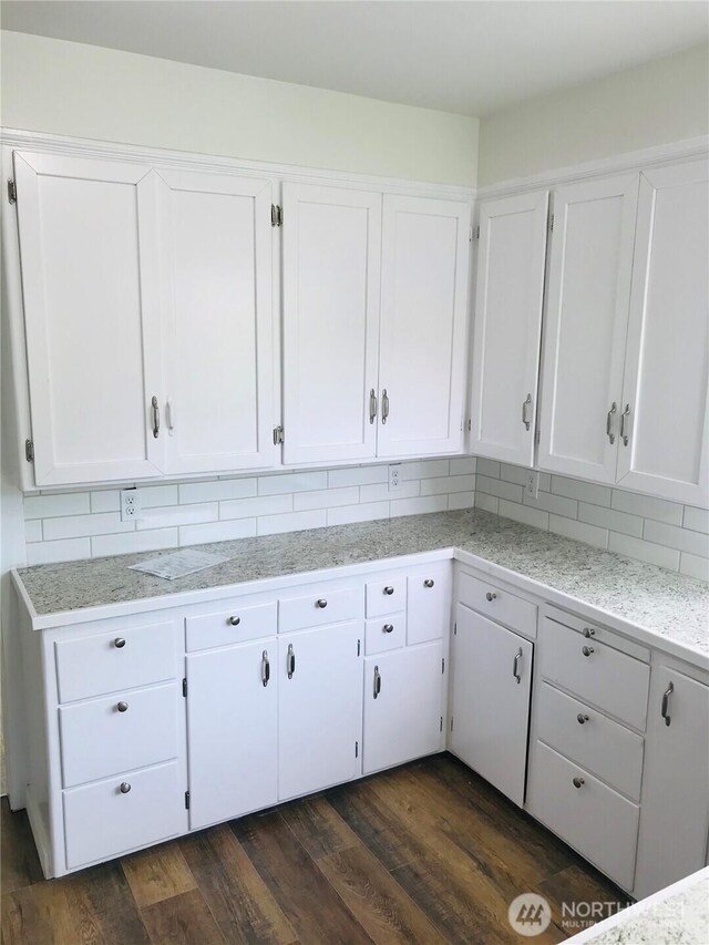 201 S 60th St, Tacoma, WA 98408 - kitchen featuring white cabinetry, decorative backsplash, light countertops, and dark wood-style floors