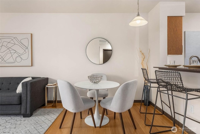 413 NE 70th St Unit 402, Seattle, WA 98115 - dining area with baseboards and wood finished floors
