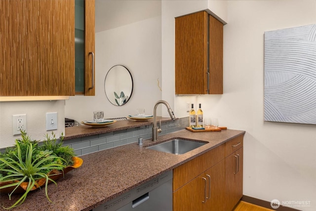 413 NE 70th St Unit 402, Seattle, WA 98115 - kitchen featuring a sink, dishwasher, glass insert cabinets, brown cabinetry, and dark stone counters
