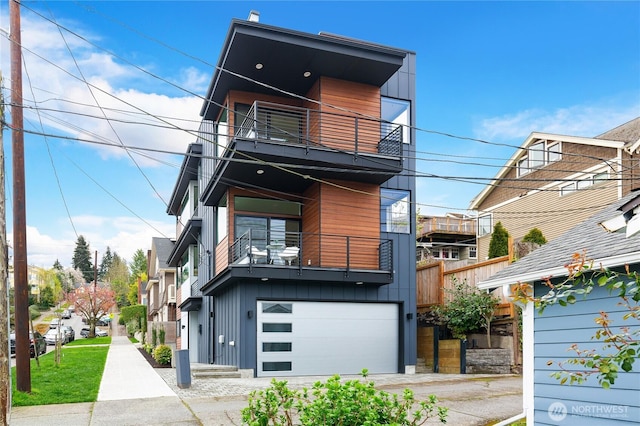 3111 Queen Anne Ave N, Seattle, WA 98119 - modern home featuring an attached garage, driveway, and a balcony