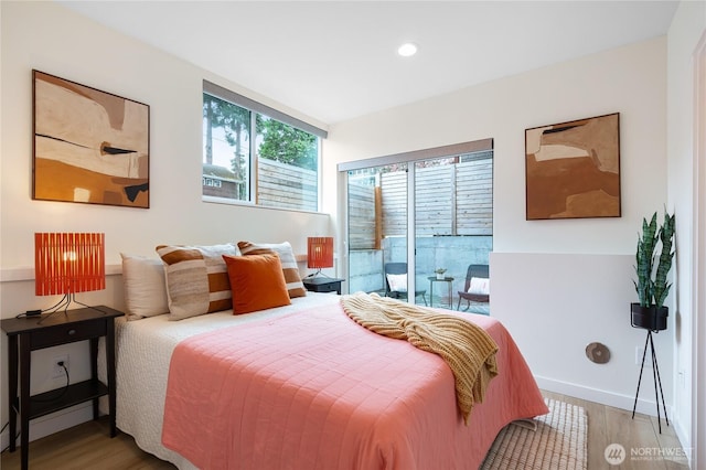 3111 Queen Anne Ave N, Seattle, WA 98119 - bedroom with access to exterior, wood finished floors, baseboards, and recessed lighting