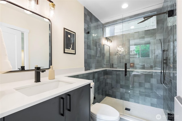 3111 Queen Anne Ave N, Seattle, WA 98119 - full bathroom featuring radiator heating unit, toilet, vanity, and a stall shower
