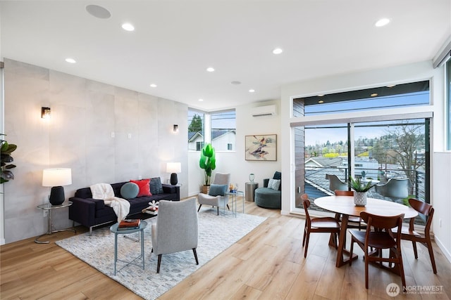 3111 Queen Anne Ave N, Seattle, WA 98119 - living area with light wood-type flooring, a wall mounted AC, and recessed lighting