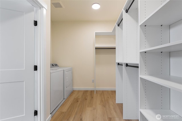 3111 Queen Anne Ave N, Seattle, WA 98119 - walk in closet featuring visible vents, light wood-style flooring, and separate washer and dryer