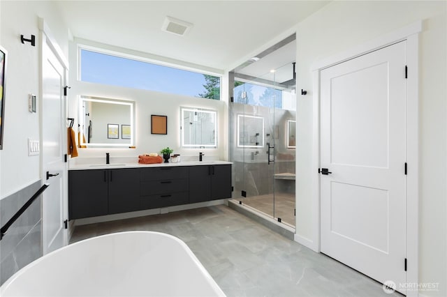 3111 Queen Anne Ave N, Seattle, WA 98119 - bathroom with a freestanding tub, double vanity, a sink, and a stall shower