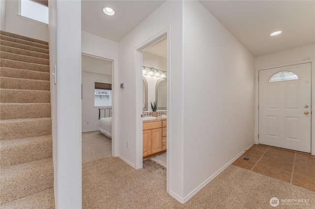 foyer featuring recessed lighting, stairway, light carpet, and baseboards