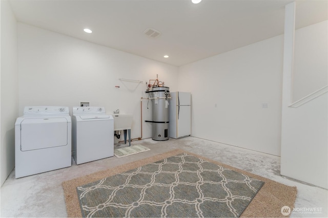 clothes washing area with laundry area, washing machine and clothes dryer, visible vents, and recessed lighting